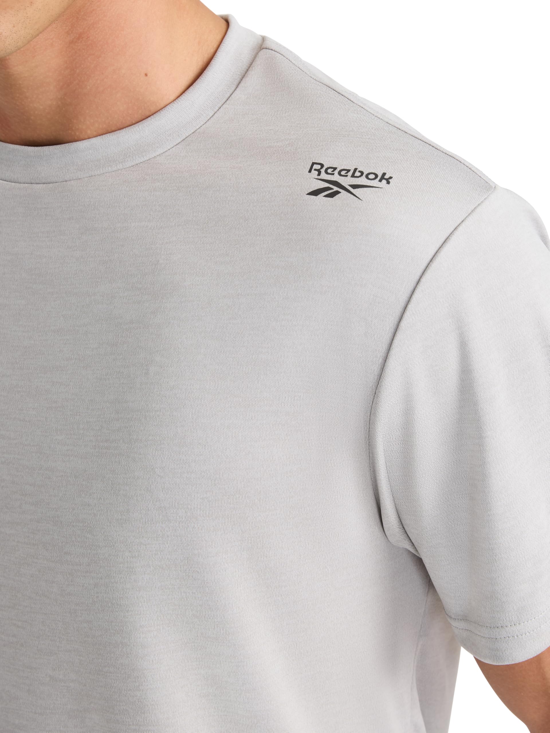Reebok Men's Small Logo Short Sleeve Crewneck T-Shirt, Standard Fit, Breathable Lightweight Stretch Knit Fabric thumbnail